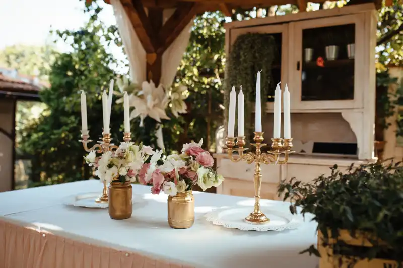 rustic candlestick and flower arrangement on table at wedding reception